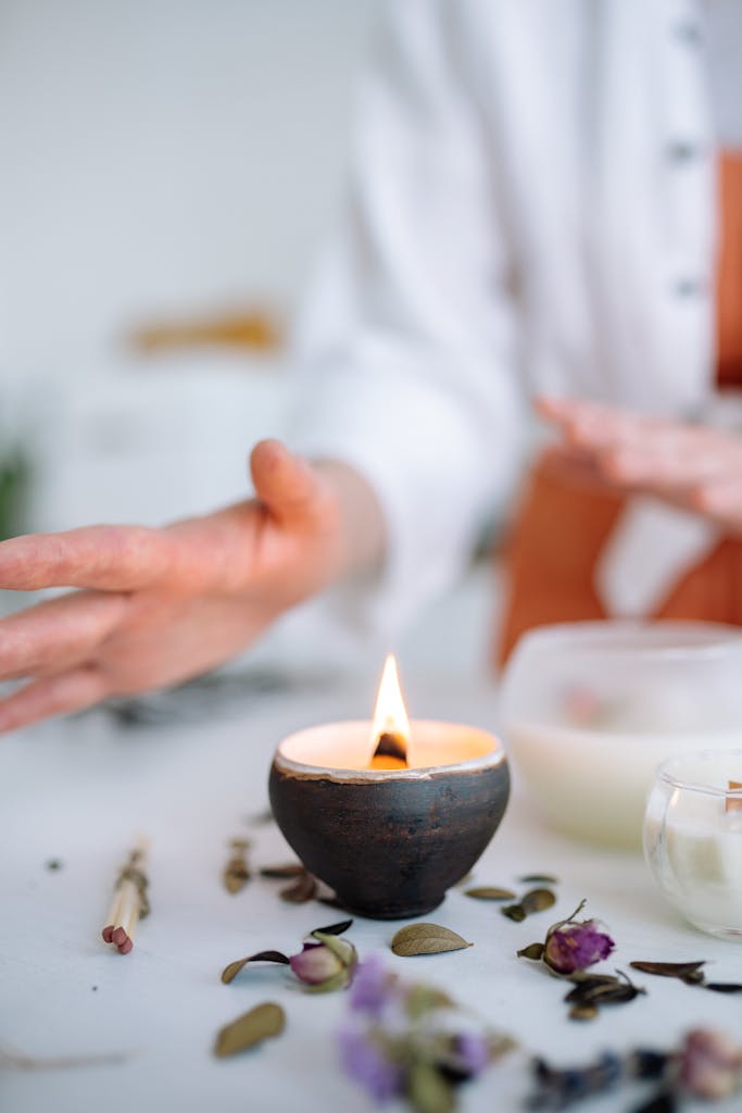 Close-up of hands crafting candles with a soothing atmosphere, perfect for relaxation.